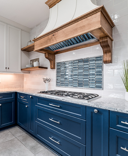 A kitchen with blue cabinets and white walls.