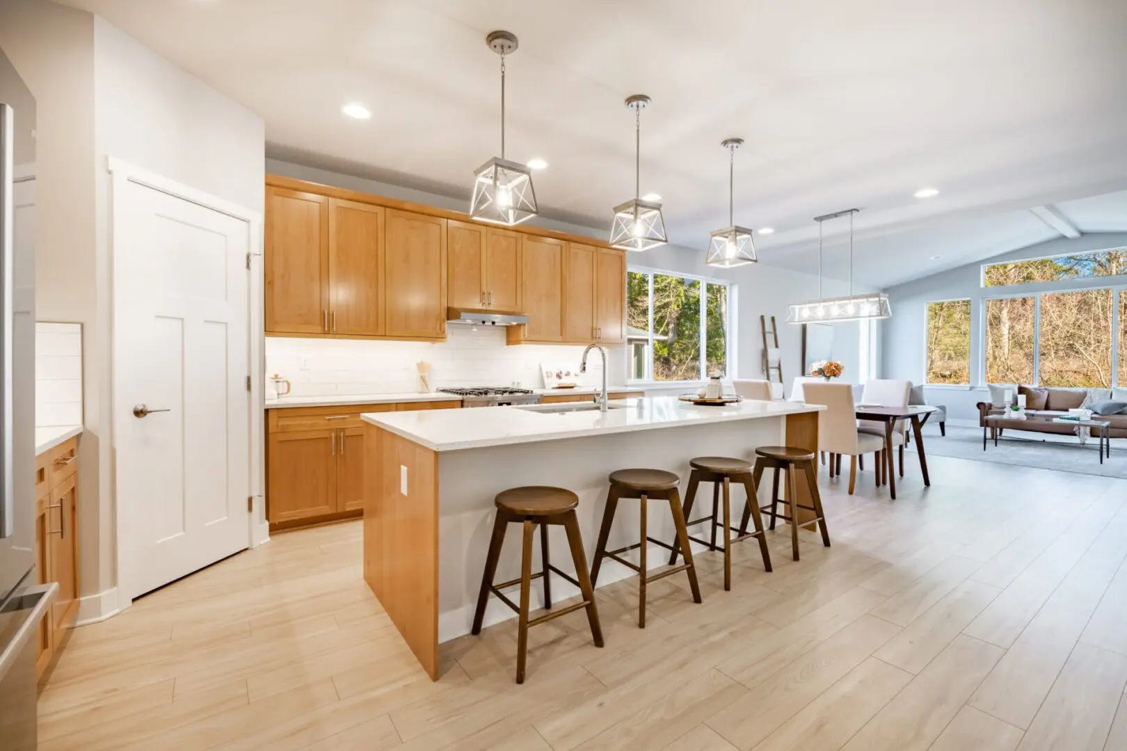 A kitchen with wooden cabinets and white counter tops.